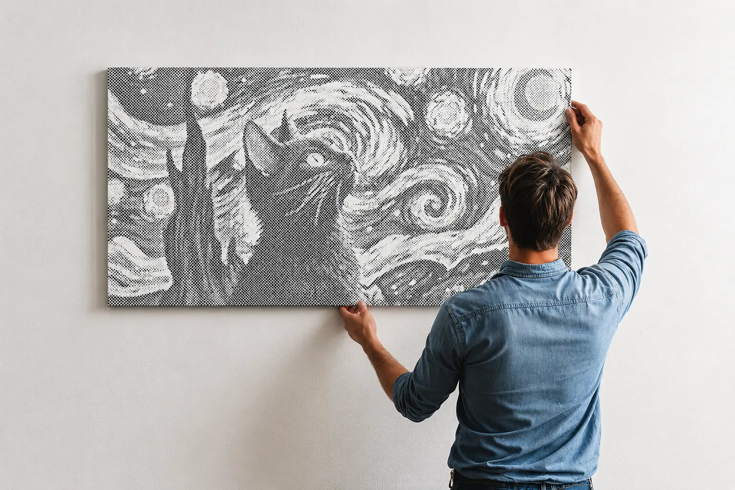 Person hanging a framed artwork of a cat on a wall with a starry night design.