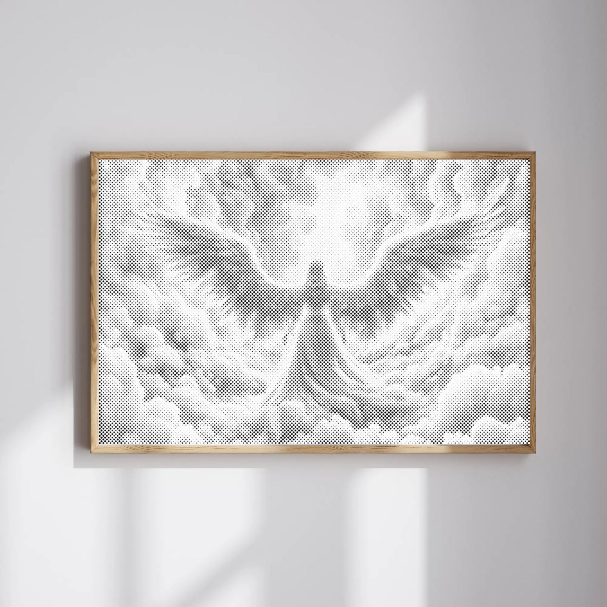 Framed Dot Painting artwork of an angel on a white wall