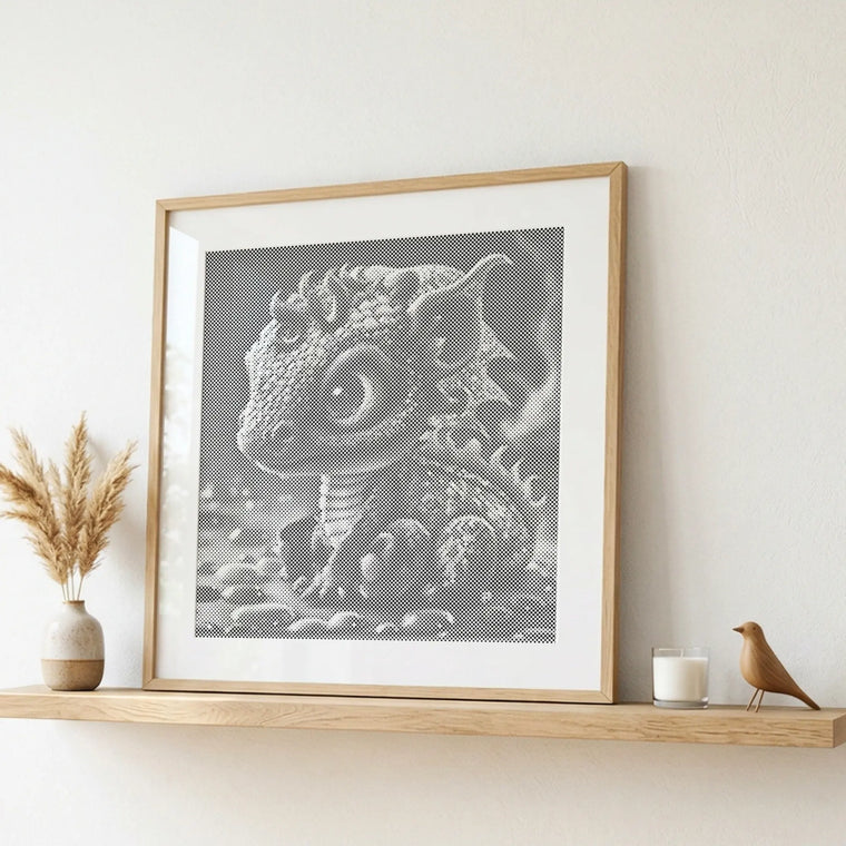 Framed artwork of a dragon on a shelf with decorative items. Baby Dragon | Dot Painting Kit