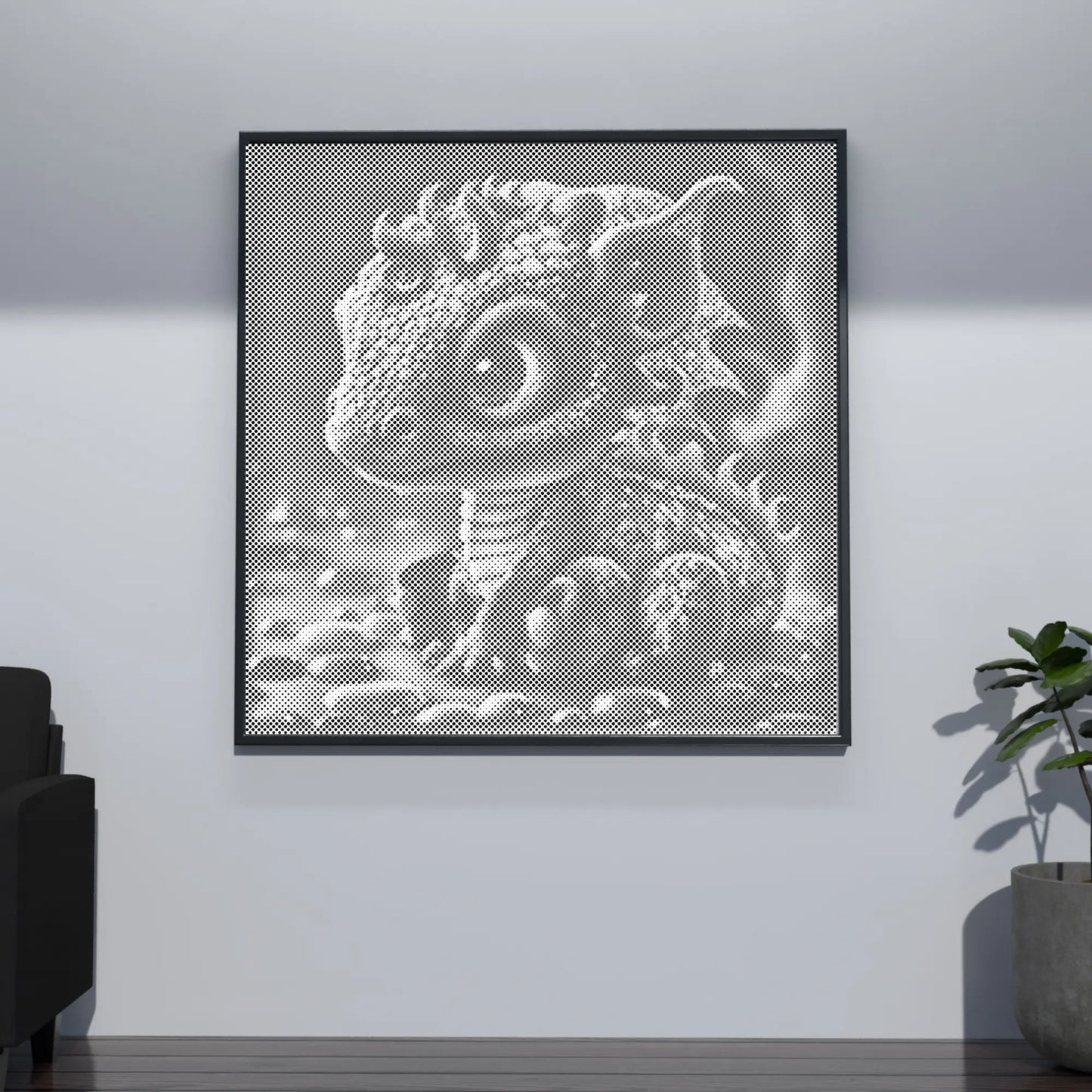 Framed artwork of a lizard on a white wall in a room with a plant and sofa. Baby Dragon | Dot Painting Kit