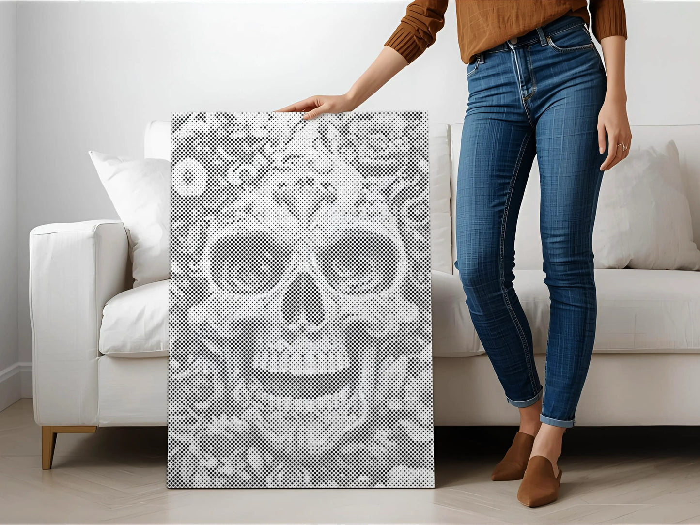 Person holding a decorative panel with a skull design in a living room. Floral Skull | Dot Painting Kit