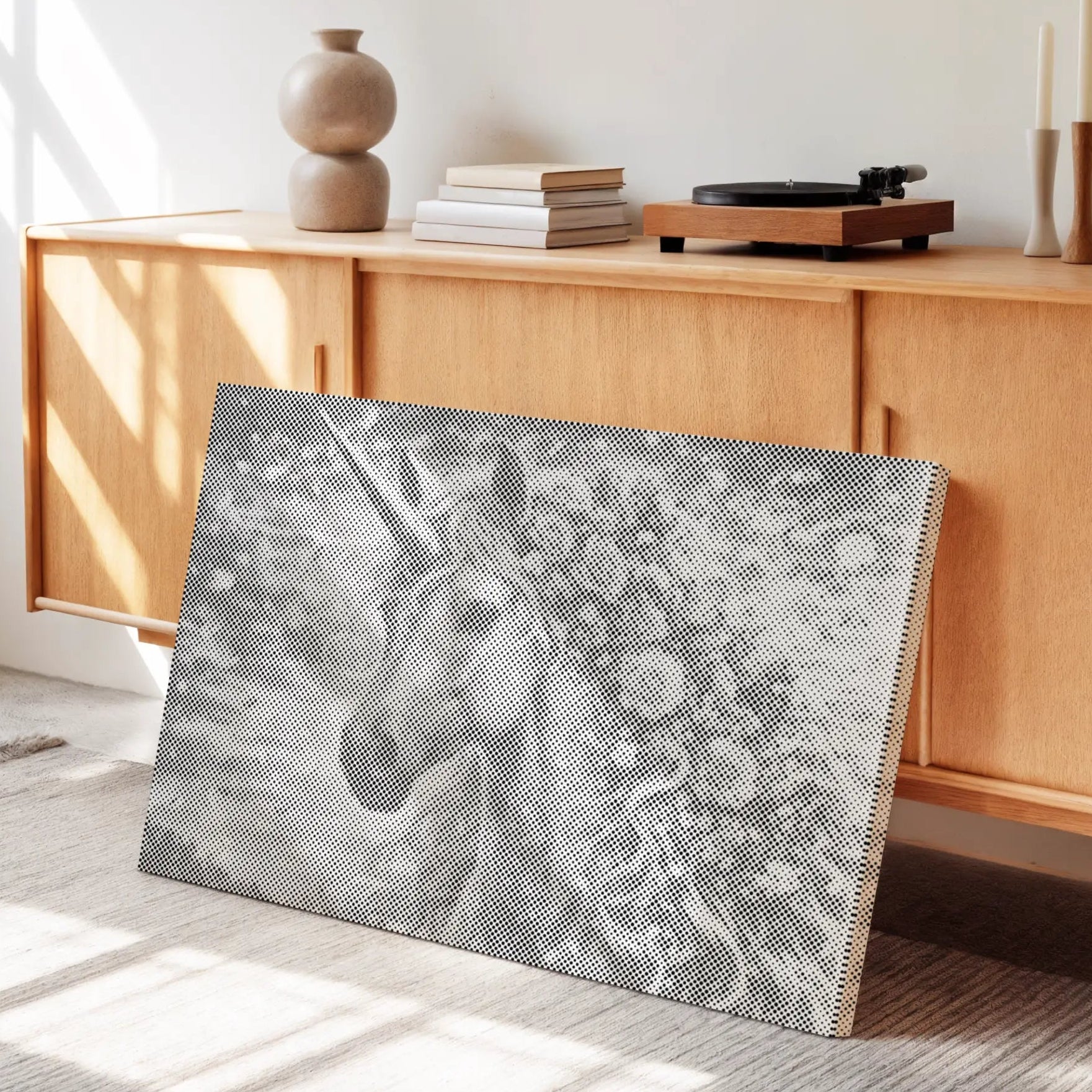 Decorative wall art with a horse design on a textured surface in a room with wooden furniture and sunlight.