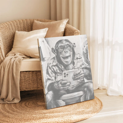 Canvas print of a monkey holding a phone on a wicker chair with beige cushions.