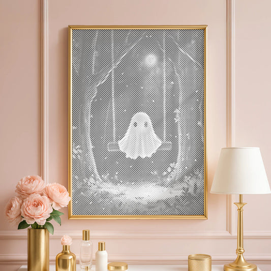 Decorative setup with a framed artwork of a ghost, flowers, and a lamp on a white surface against a pink wall.