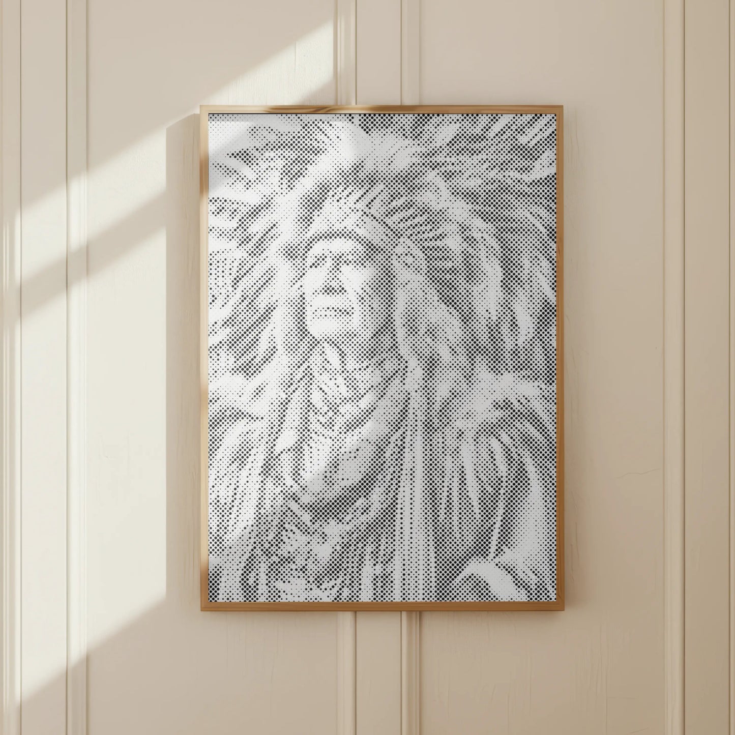 Framed artwork of a person wearing a headdress on a beige wall.