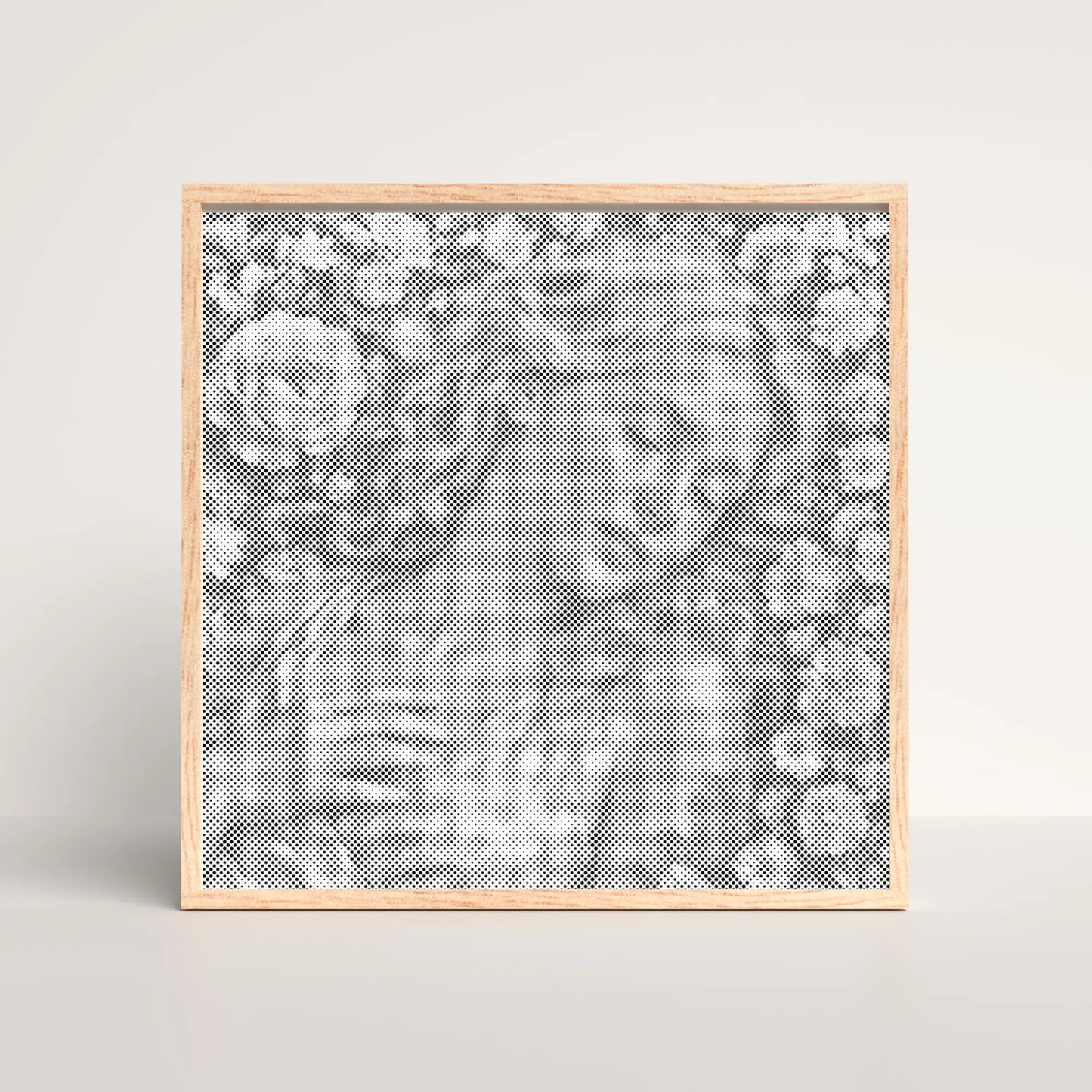 Framed artwork with a pattern of flowers and leaves on a light gray background