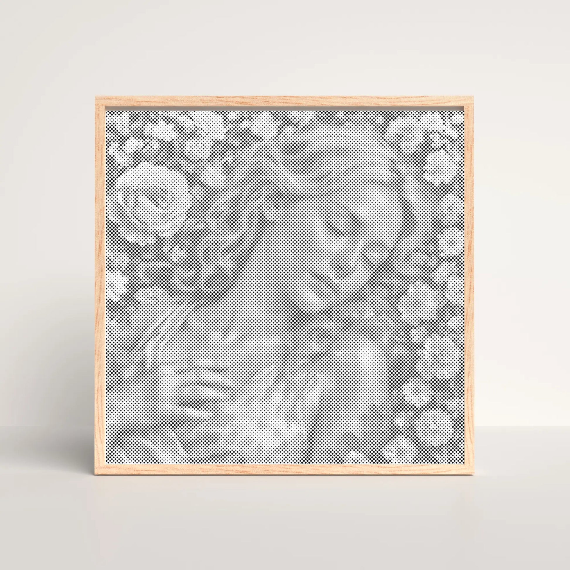Framed artwork with a pattern of flowers and leaves on a light gray background