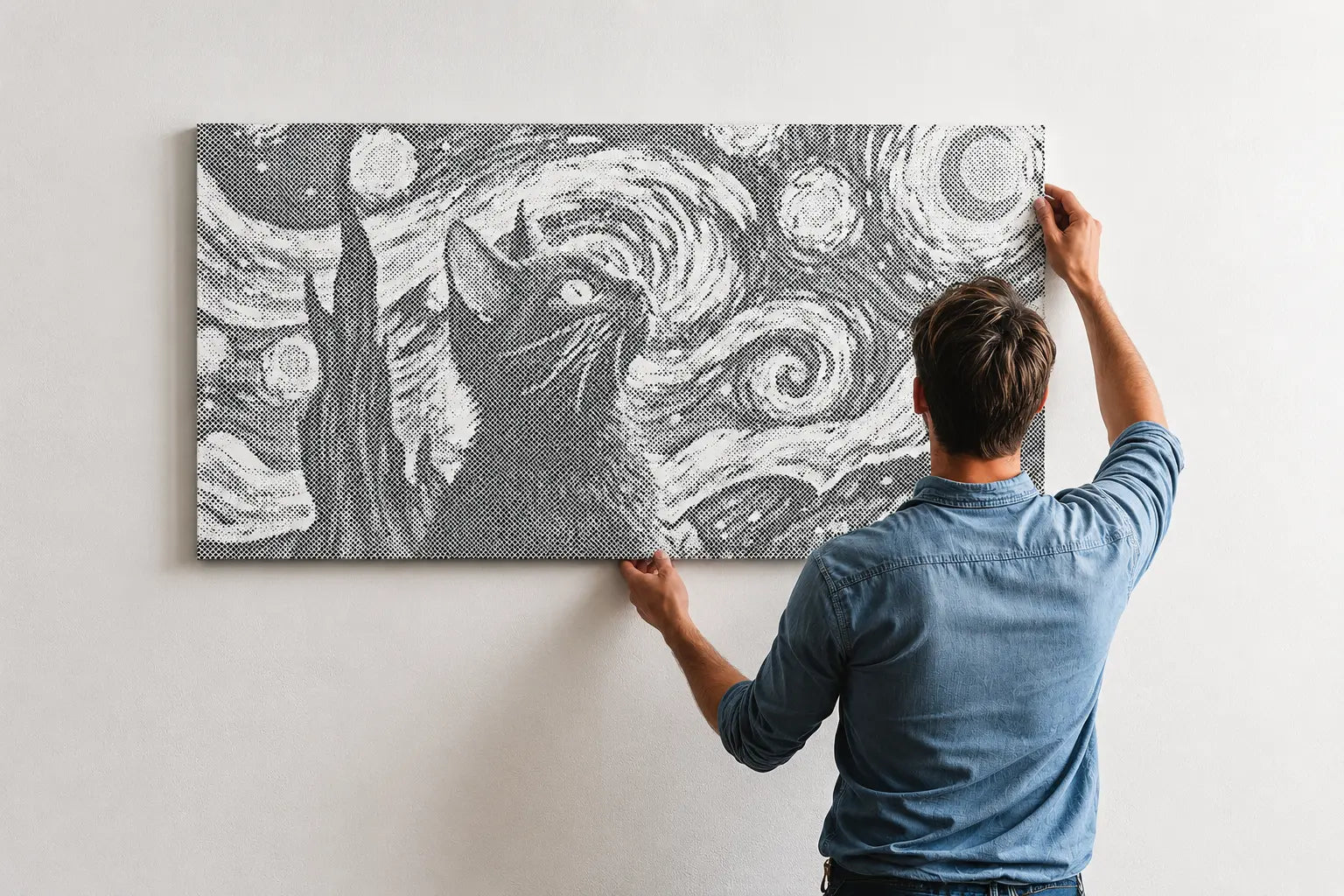 Person hanging a framed artwork of a cat on a wall with a starry night design.