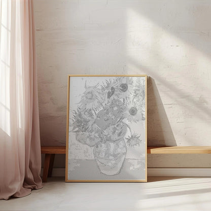Framed artwork on a wall next to a window with pink curtains 